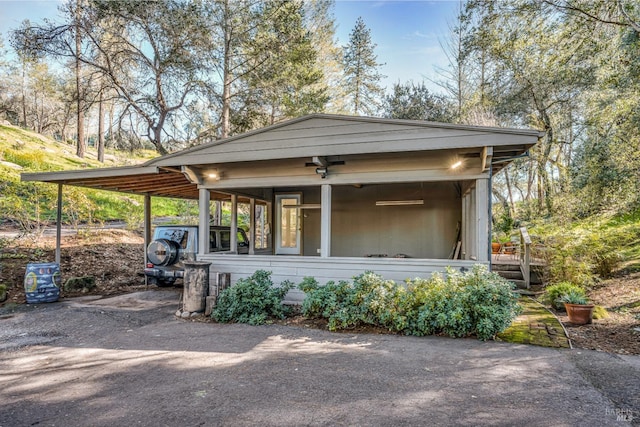 view of front of house with a carport and driveway