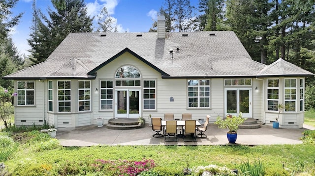 back of property with roof with shingles, a chimney, a patio area, and french doors