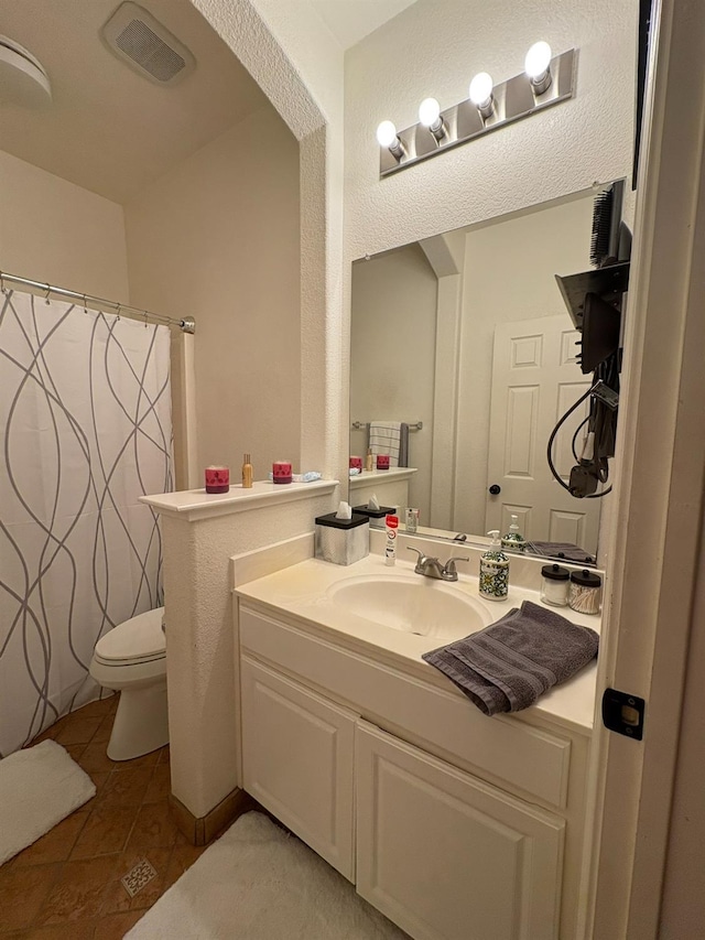 full bath with toilet, curtained shower, tile patterned flooring, and vanity