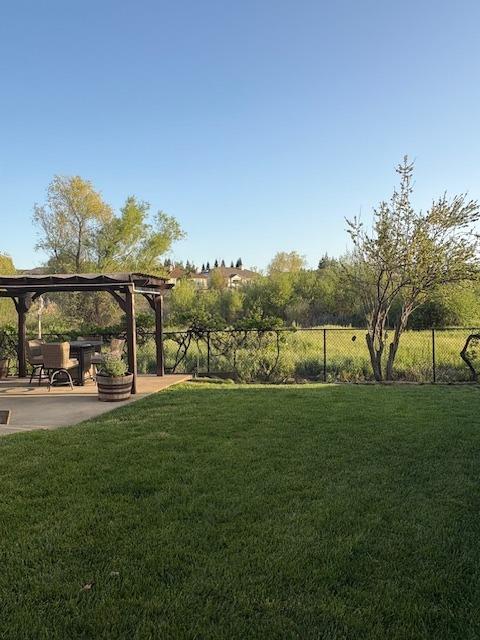 view of yard with a patio area, a pergola, and fence