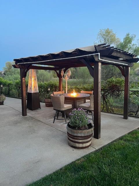 view of patio featuring an outdoor fire pit and a pergola