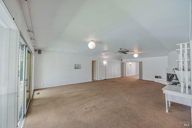 unfurnished living room with ceiling fan and carpet flooring