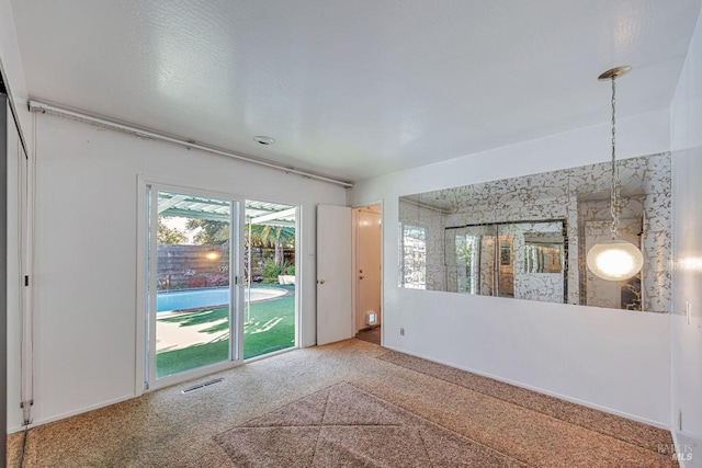 carpeted spare room with visible vents