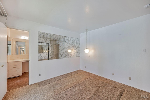 carpeted spare room with baseboards
