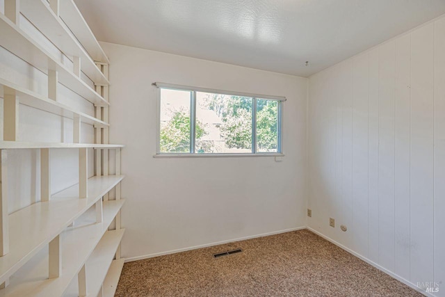 carpeted empty room with baseboards and visible vents