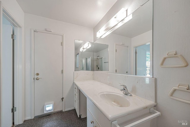 full bathroom with vanity and an enclosed shower