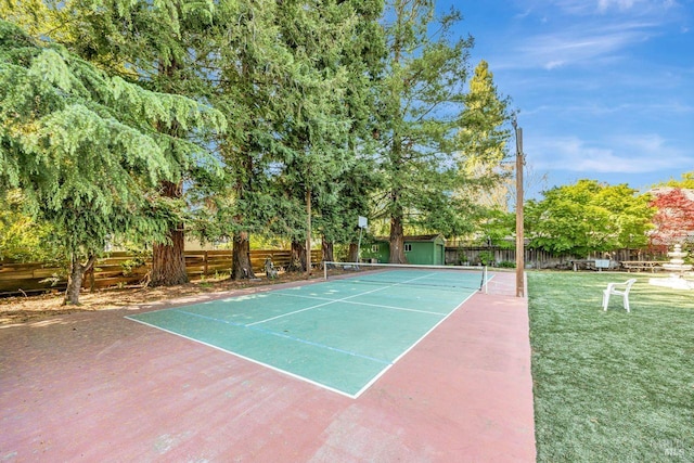 view of sport court featuring fence