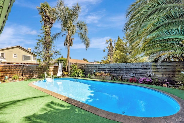 view of swimming pool with a fenced backyard and a fenced in pool