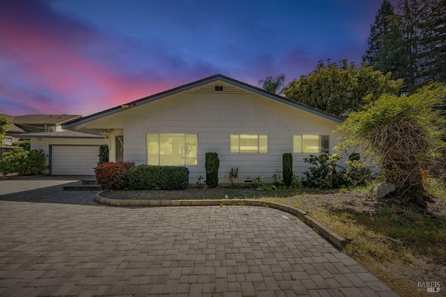 view of front facade featuring decorative driveway and a garage