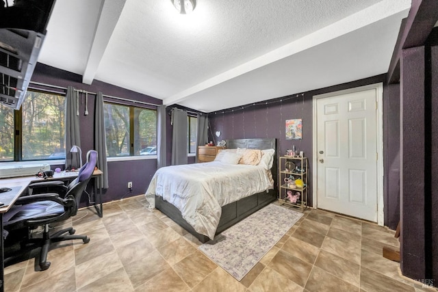 bedroom with a textured ceiling and vaulted ceiling with beams