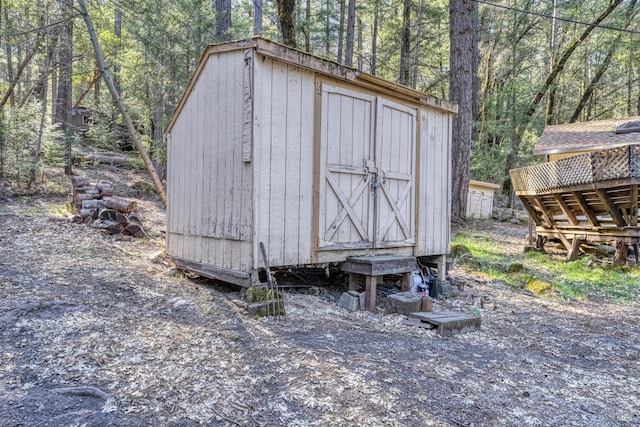 view of shed with a wooded view