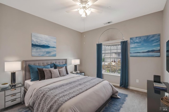 carpeted bedroom featuring visible vents, baseboards, and a ceiling fan