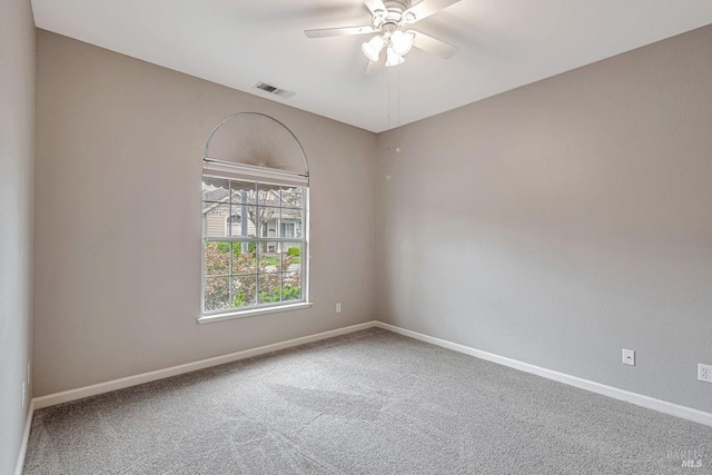 spare room featuring ceiling fan, baseboards, carpet flooring, and visible vents