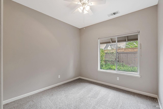 spare room with visible vents, baseboards, a ceiling fan, and carpet floors