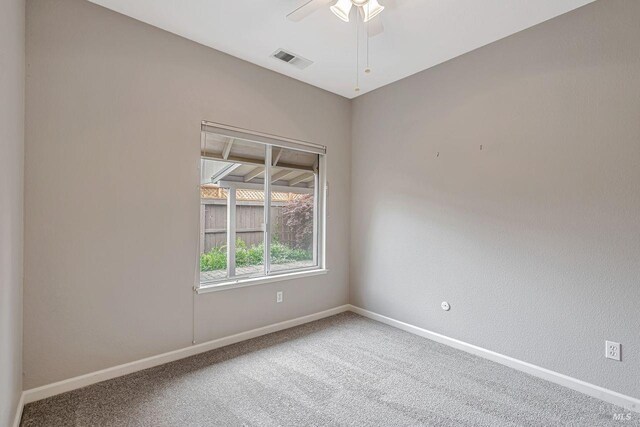 unfurnished room featuring visible vents, baseboards, ceiling fan, and carpet flooring