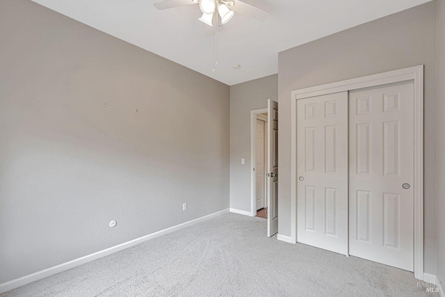 unfurnished bedroom featuring a closet, baseboards, a ceiling fan, and carpet floors
