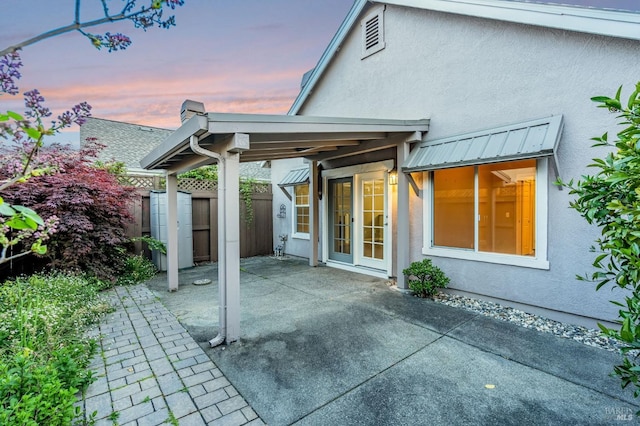back of property with a patio area, stucco siding, and fence