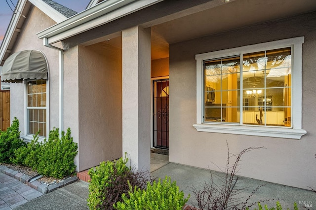 view of exterior entry with stucco siding