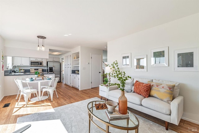 141 Albatrosse Way, Vallejo, CA 94589 - living room with visible vents, baseboards, and light wood finished floors