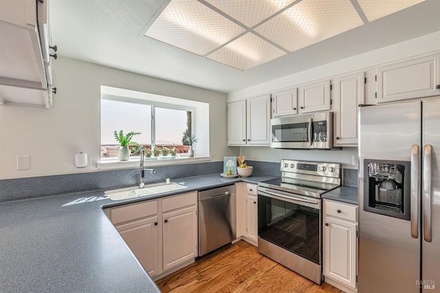 141 Albatrosse Way, Vallejo, CA 94589 - kitchen with a sink, dark countertops, light wood-style floors, white cabinetry, and stainless steel appliances