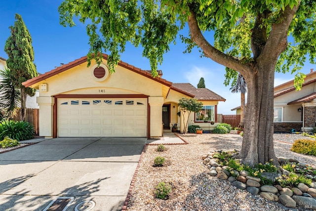 141 Albatrosse Way, Vallejo, CA 94589 - mediterranean / spanish home featuring a tiled roof, stucco siding, fence, an attached garage, and driveway