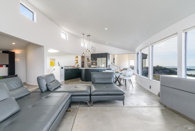living area with concrete floors, high vaulted ceiling, baseboards, and recessed lighting