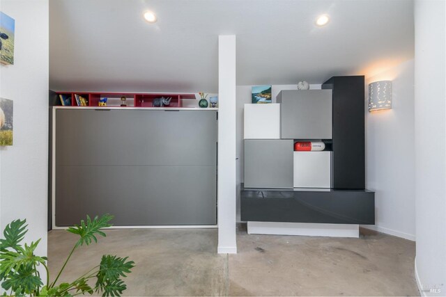 interior space with baseboards and recessed lighting