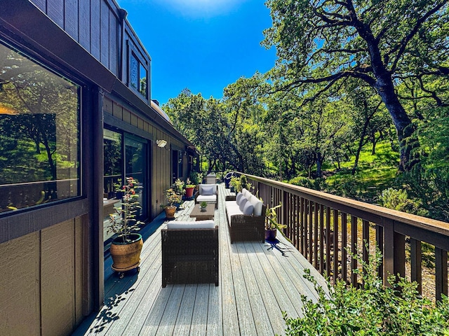wooden terrace featuring an outdoor hangout area