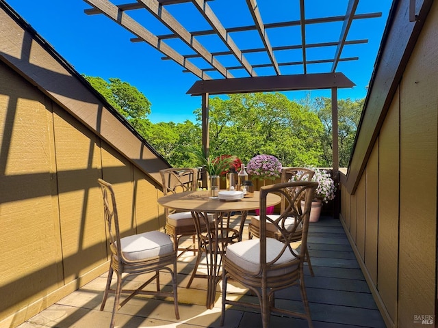 balcony featuring outdoor dining space and a pergola