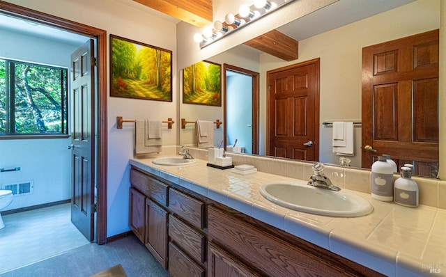 bathroom featuring double vanity, visible vents, and a sink