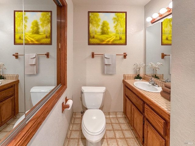 bathroom featuring toilet and vanity
