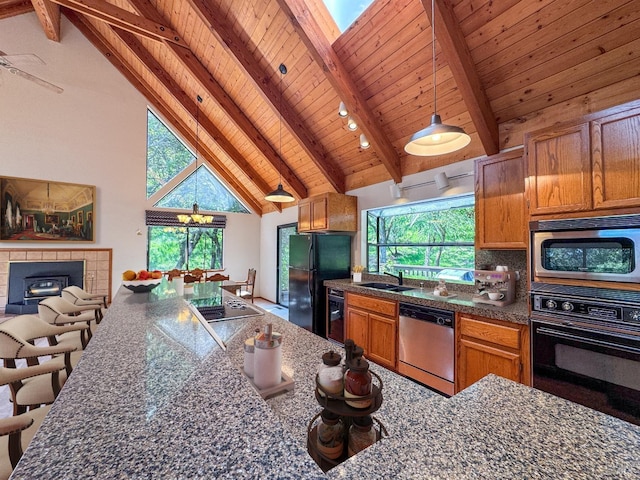 kitchen with wooden ceiling, dark countertops, beamed ceiling, black appliances, and pendant lighting