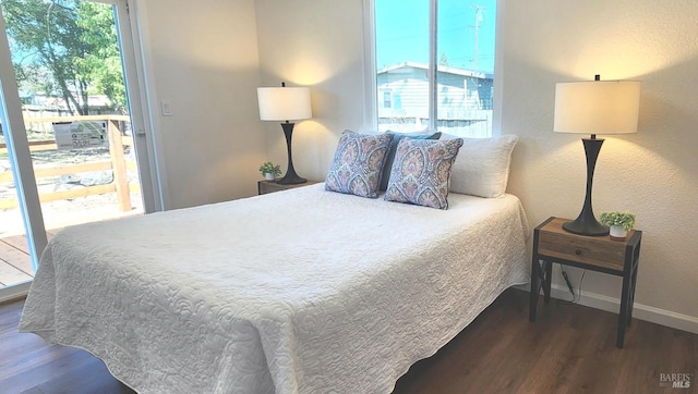 bedroom with baseboards and wood finished floors