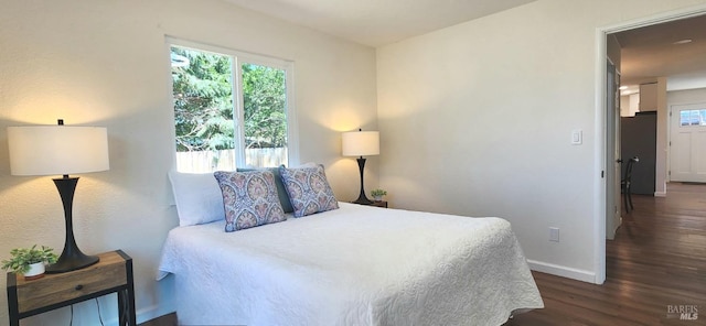 bedroom with baseboards and wood finished floors