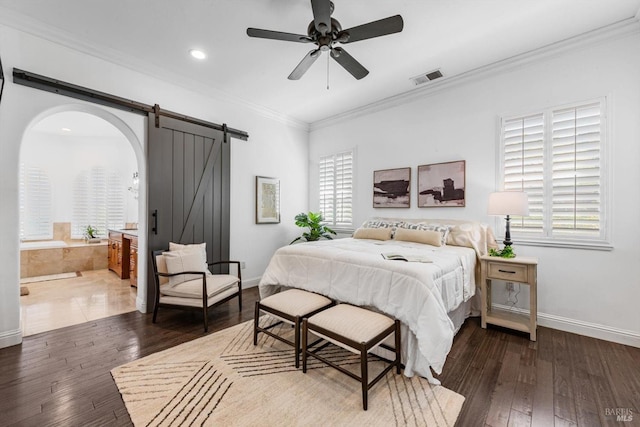bedroom featuring dark wood-style floors, a barn door, visible vents, multiple windows, and crown molding