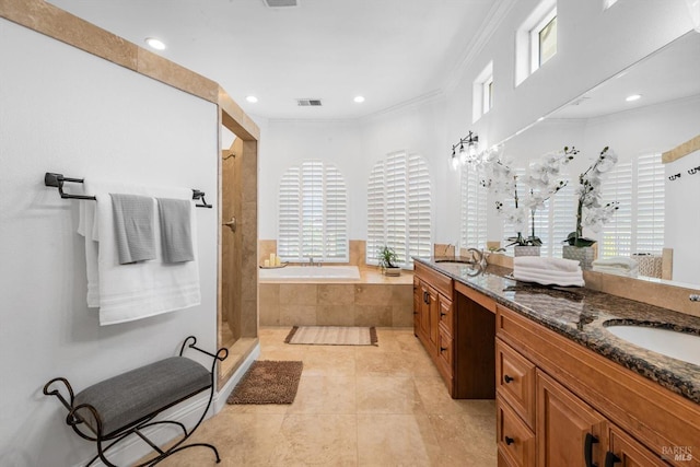 bathroom featuring a wealth of natural light, visible vents, a sink, and a shower stall