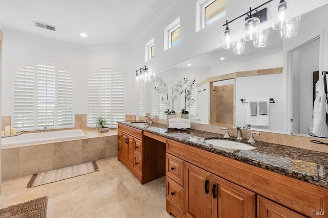 full bath featuring double vanity, visible vents, a sink, crown molding, and a stall shower