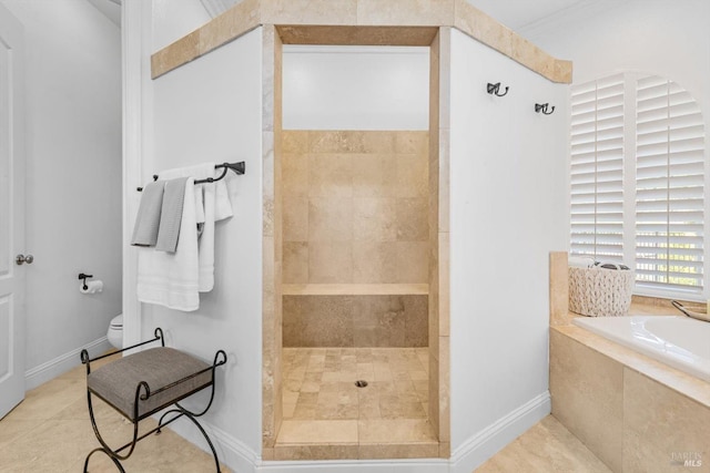 full bathroom featuring tile patterned floors, a bath, baseboards, toilet, and a walk in shower