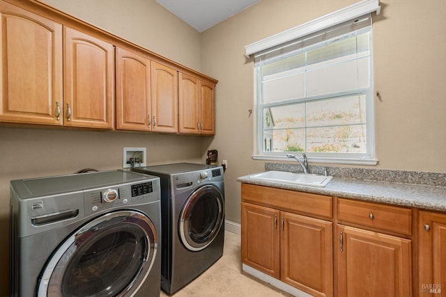 clothes washing area with light tile patterned floors, cabinet space, a sink, and independent washer and dryer