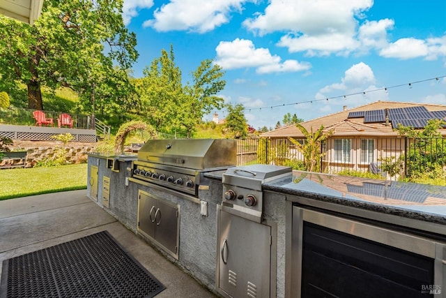 view of patio with exterior kitchen, a grill, and a deck