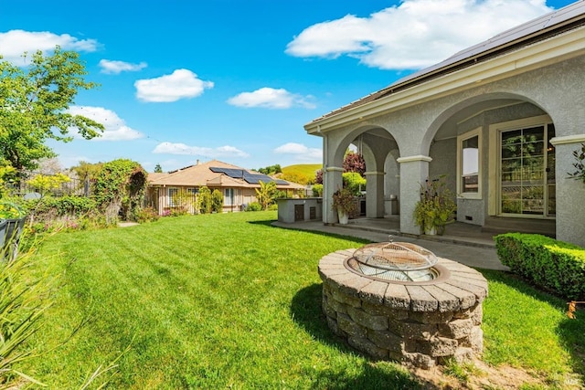 view of yard featuring a fire pit and fence
