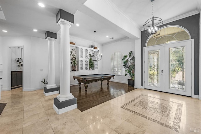 tiled entrance foyer with a notable chandelier, decorative columns, crown molding, billiards, and french doors