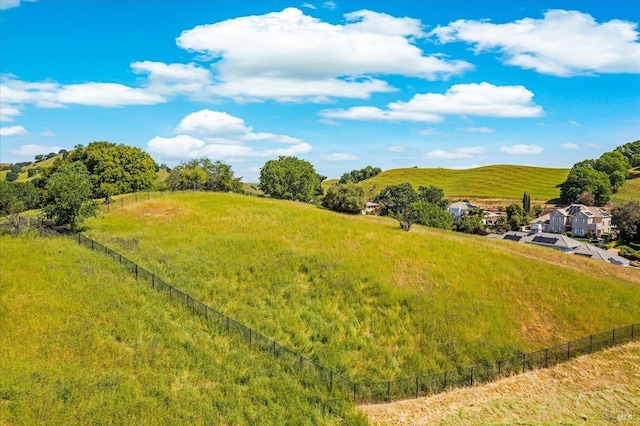 view of yard with a rural view and fence