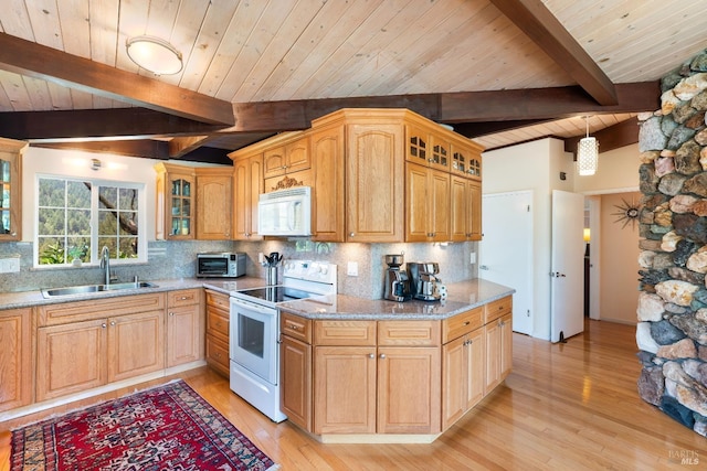 kitchen with a sink, beamed ceiling, white appliances, and wood ceiling