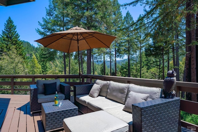 deck featuring a view of trees and an outdoor hangout area