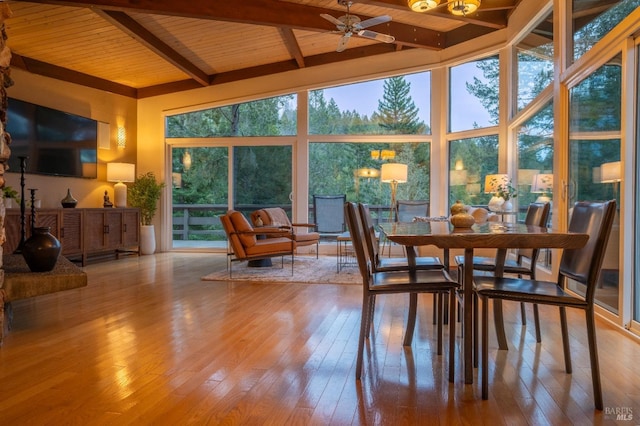 sunroom / solarium featuring plenty of natural light and beam ceiling