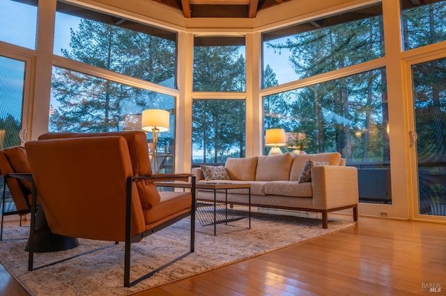 sunroom / solarium featuring wood-type flooring and a deck