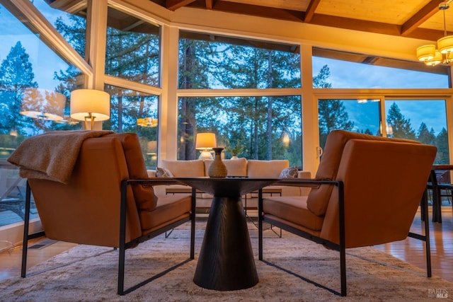 sunroom with beam ceiling and a chandelier