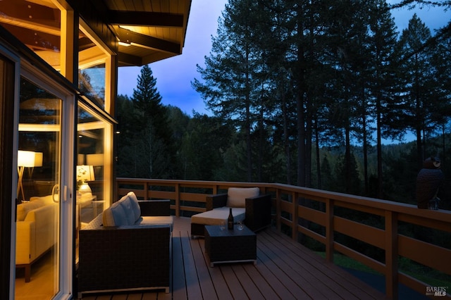 deck at dusk featuring an outdoor living space