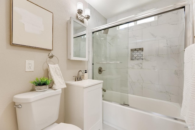 full bathroom featuring toilet, vanity, and bath / shower combo with glass door